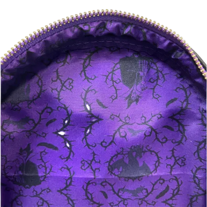 Close-up of a purple fabric with black floral patterns inside a zipper pouch.