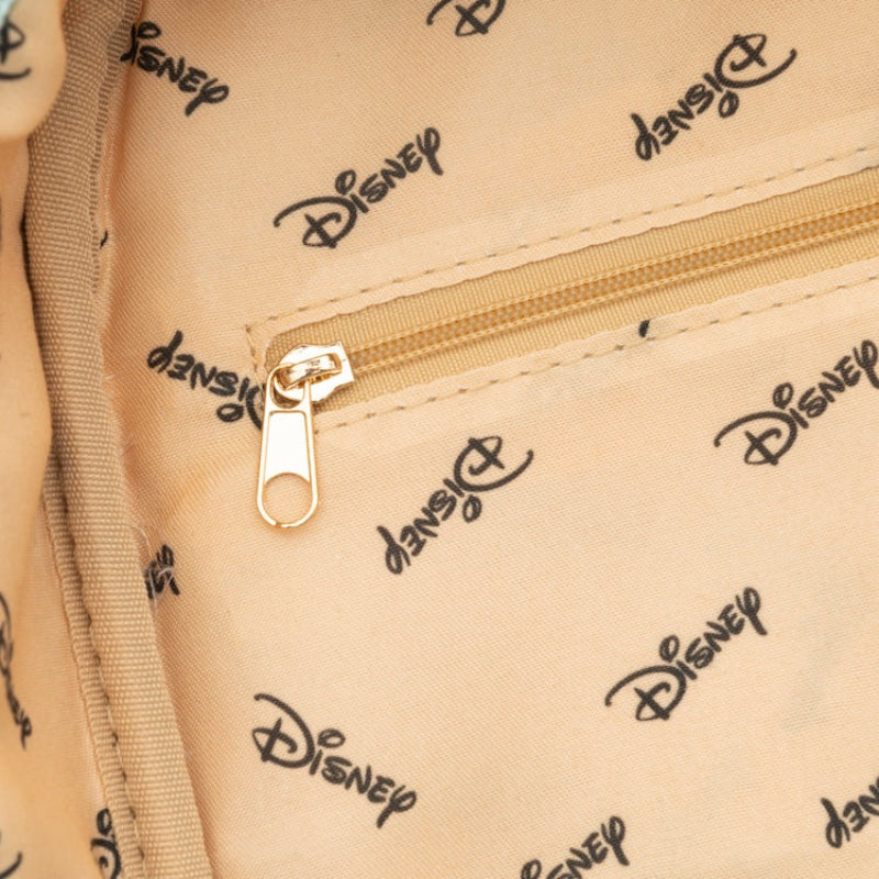 Close-up of a beige bag with Disney logo pattern and gold zipper.