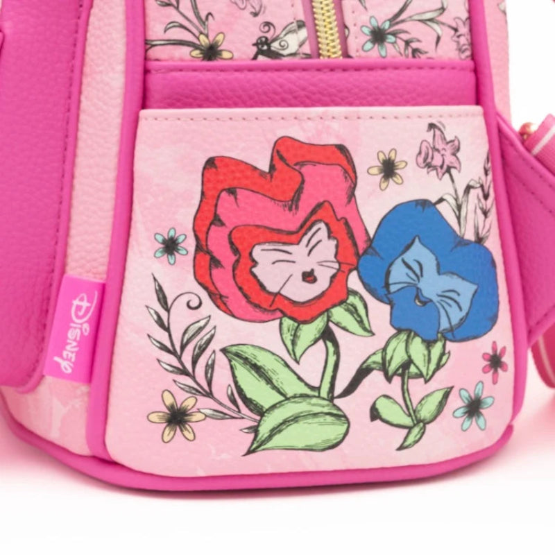 Close-up of a pink Disney bag featuring a front pocket with a red flower and a blue flower illustration, alongside a pink Disney tag on the side.