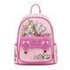 A pink Disney-themed mini backpack featuring Alice in Wonderland artwork, including Alice and the Cheshire Cat, with a prominent pink front pocket and a gold-tone Disney logo.
