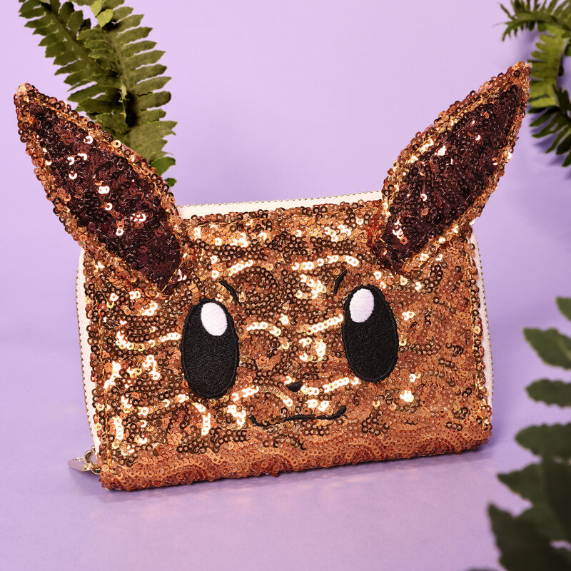 Sequined pouch with cat face design on a purple background