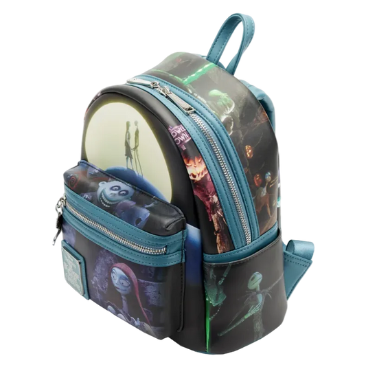 A small backpack with a Disney Tim Burton 'The Nightmare Before Christmas' character print, featuring teal blue zippers and trim, a circular character patch, and a matching zippered front pouch.
