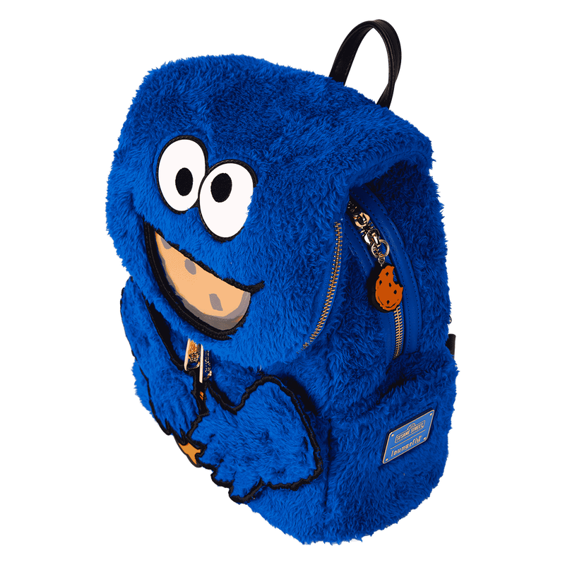 Blue furry backpack with a smiling face design on a white background