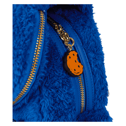 Blue fuzzy jacket with a gold zipper and orange pumpkin charm on a white background