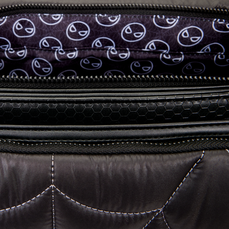 Close-up of a black quilted bag with a patterned interior.