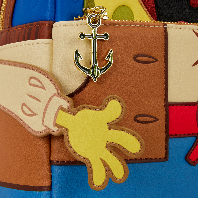 Close-up of a colorful bag with a keychain featuring a yellow hand and anchor.