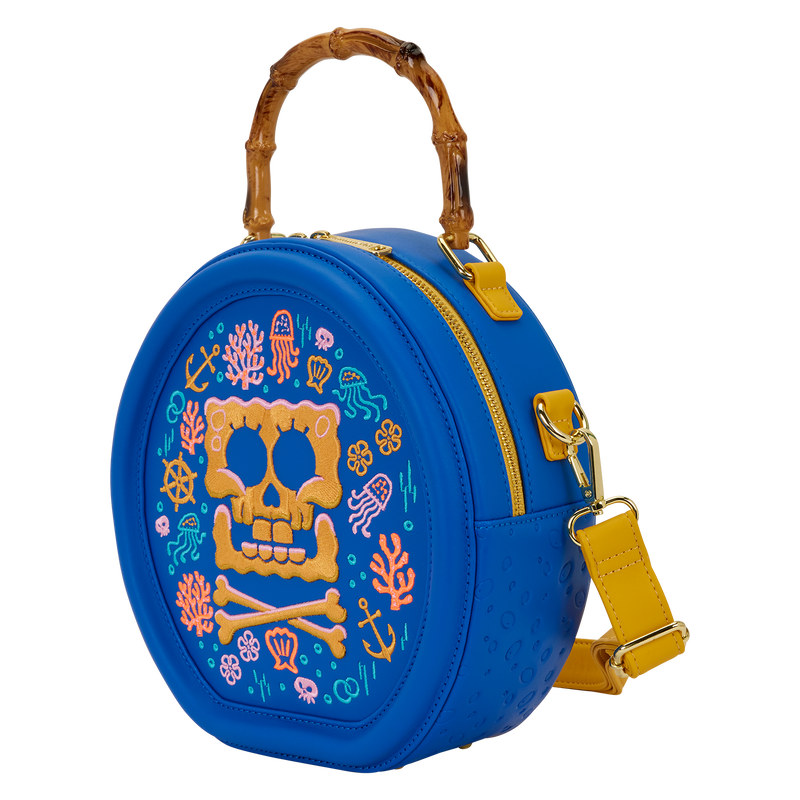 Blue round bag with colorful skull design and yellow strap on a white background