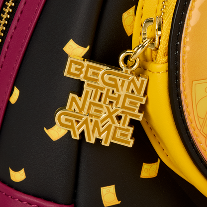 Gold 'Begin the Next Game' charm on a black and yellow bag
