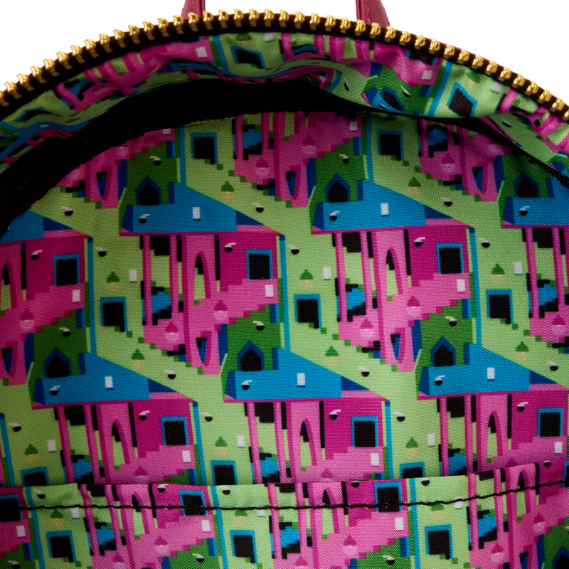 Close-up of a colorful geometric patterned bag with pink and blue shapes on a green background.
