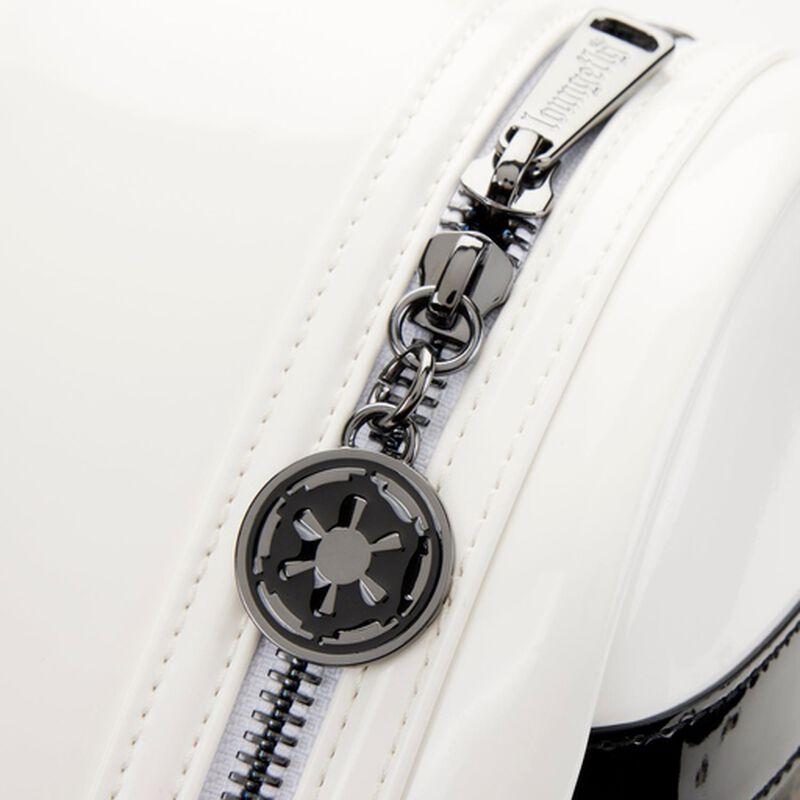 Close-up of a white bag with a silver zipper and emblem on a white background