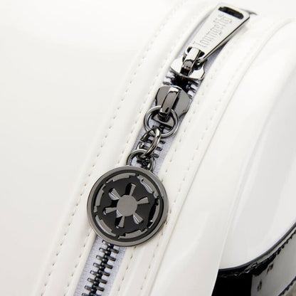 Close-up of a white bag with a silver zipper and emblem on a white background