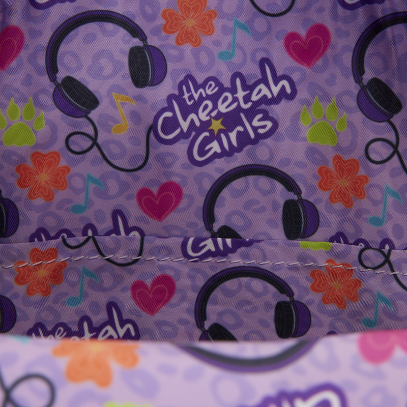 Fabric with 'the Cheetah Girls' logo, headphones, and colorful patterns on a purple background.
