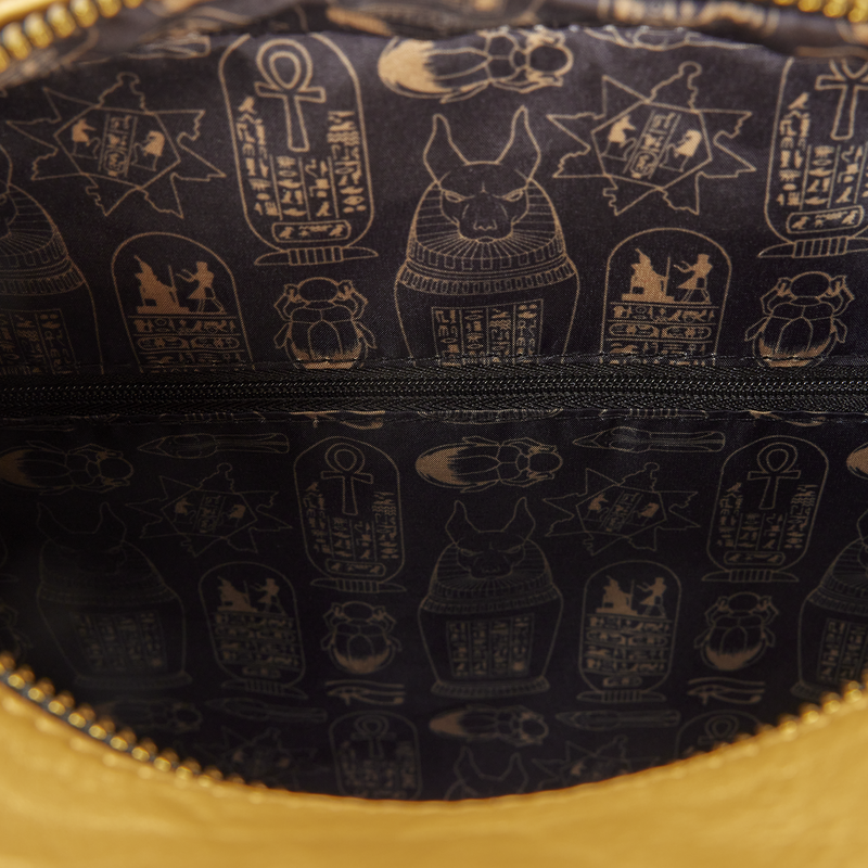 Close-up of a black bag with gold hieroglyphic patterns and gold zipper.