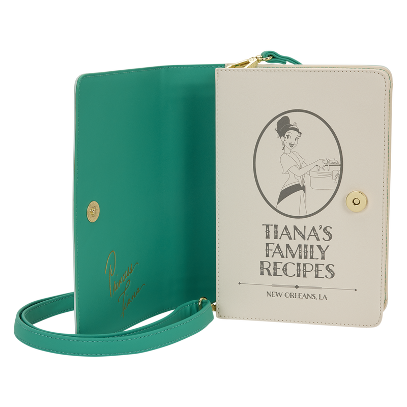 Green book with a strap and beige cover featuring 'Tiana's Family Recipes' on a white background