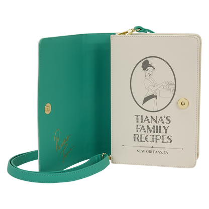 Green book with a strap and beige cover featuring 'Tiana's Family Recipes' on a white background