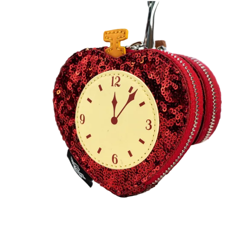 Red sequined clock-shaped keychain on a white surface