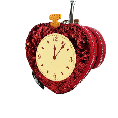 Red sequined clock-shaped keychain on a white surface