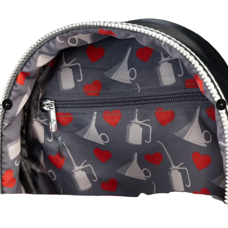 Backpack with a pattern of red hearts and gray megaphones on a dark background.