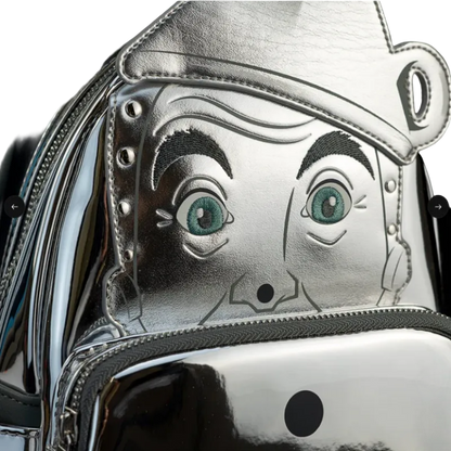 Metallic bag with cartoonish face design on a dark background