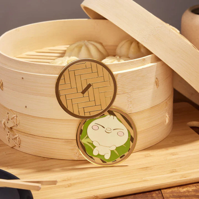 Bamboo steamer with a cartoon character lid on a wooden surface