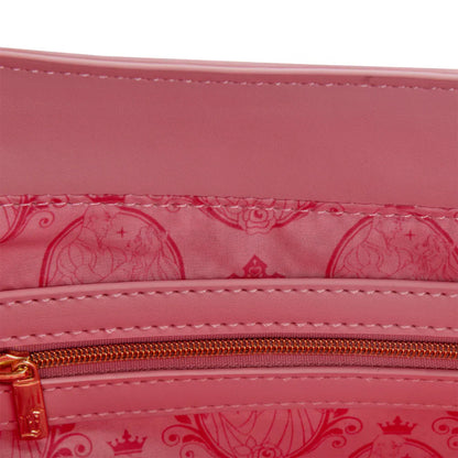 Close-up of a pink bag with a gold zipper and decorative pattern.