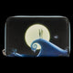 A zip-around wallet featuring a printed design of The Nightmare Before Christmas, showing Jack Skellington and Sally under a large full moon with a giant spiral wave in the foreground.
