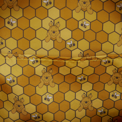 Fabric with honeycomb pattern featuring cartoon bears and bees.