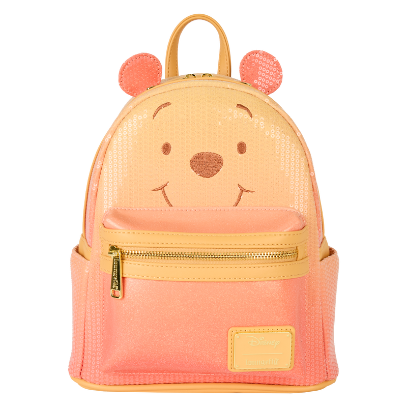 Pink and yellow backpack with bear face design on a white background