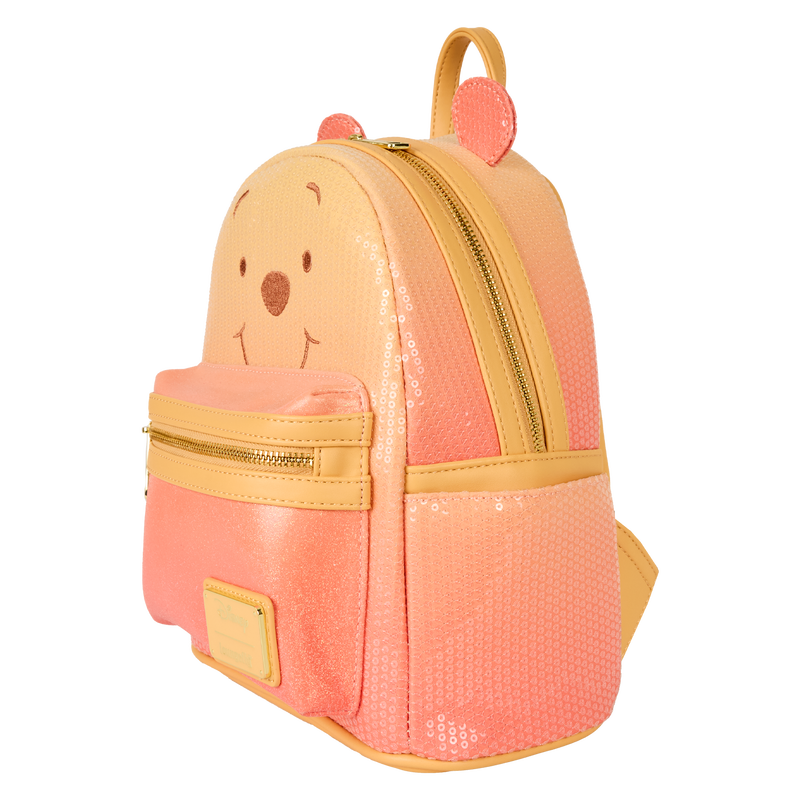 Pink and yellow backpack with bear face design on a white background
