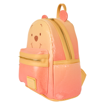 Pink and yellow backpack with bear face design on a white background