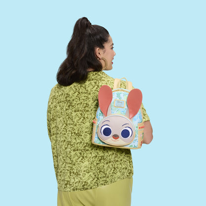 Person wearing a backpack with a cartoon character design on a blue background