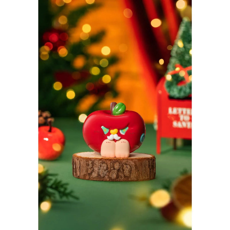 Decorative apple figurine on a wooden base with festive background