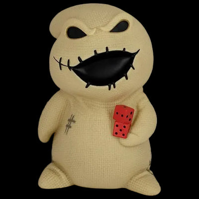 Beige plush toy with black face and red dice on a white background
