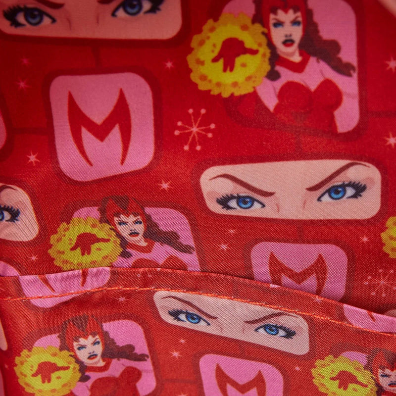 Red fabric with superhero-themed pattern featuring eyes, faces, and 'M' logo.
