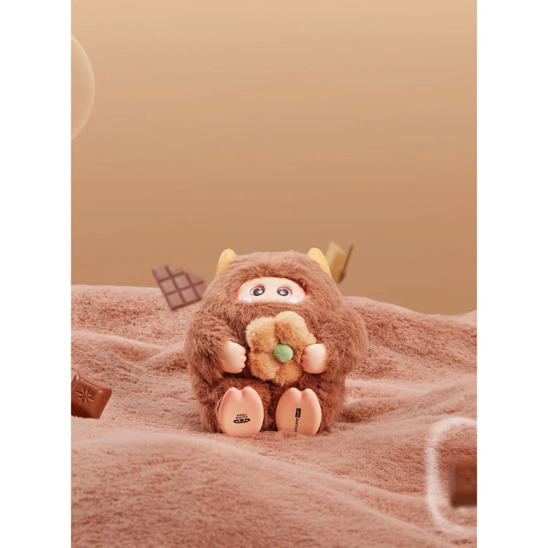 Plush toy resembling a cartoon character on a soft surface with a warm background