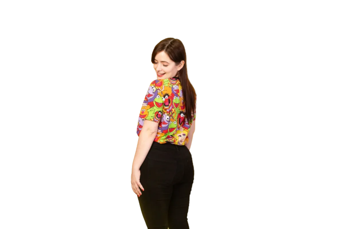 Person wearing a colorful shirt with cartoon characters on a yellow background
