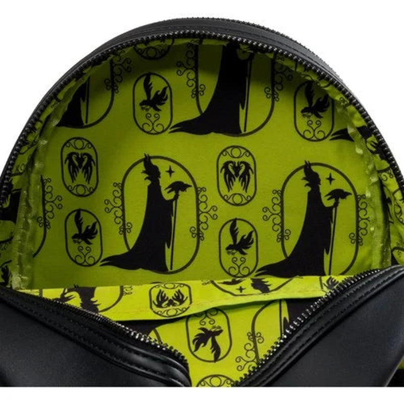 Close-up of a green bag with black silhouette patterns on a white background