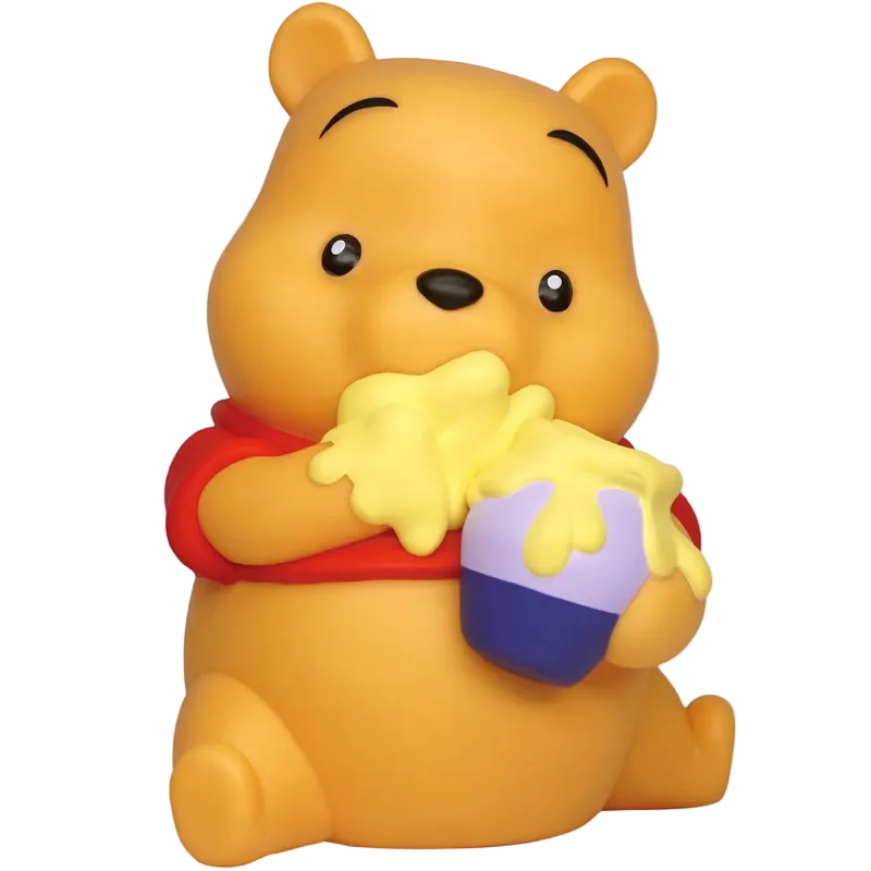A Winnie the Pooh bear figurine or bath toy in a sitting pose, holding a honey pot with yellow honey dripping over it. The bear is yellow with a red shirt, and the pot is purple and blue, set against a plain white background.
