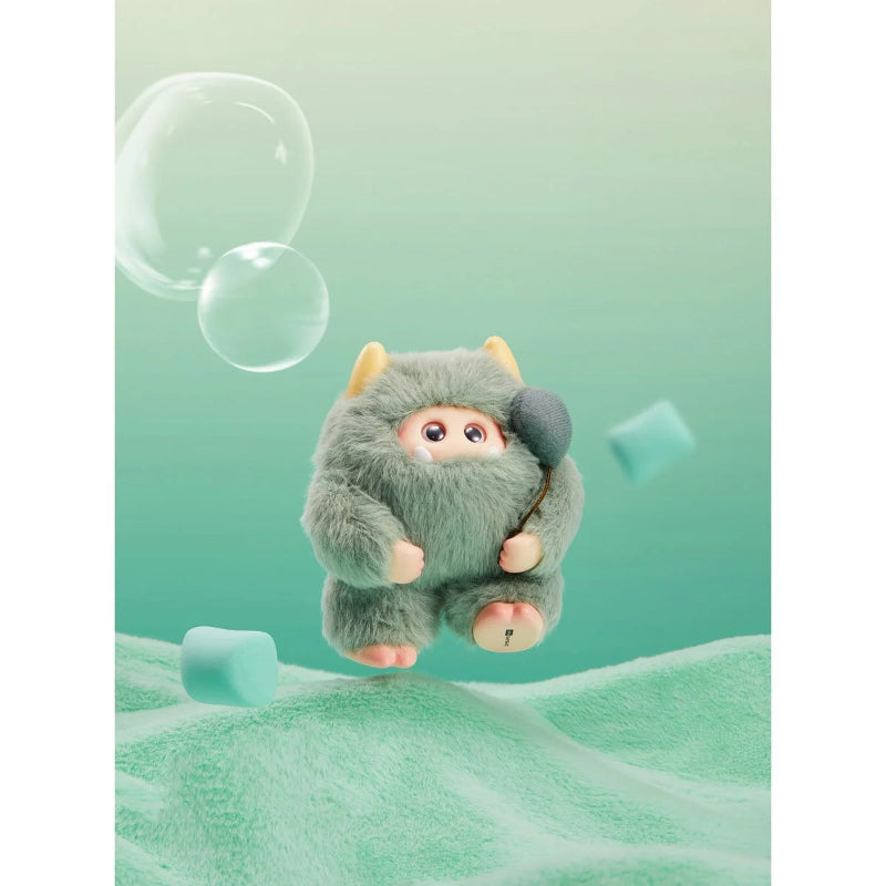Plush toy resembling a creature in a green outfit with bubbles on a light green background