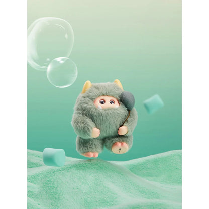Plush toy resembling a creature in a green outfit with bubbles on a light green background