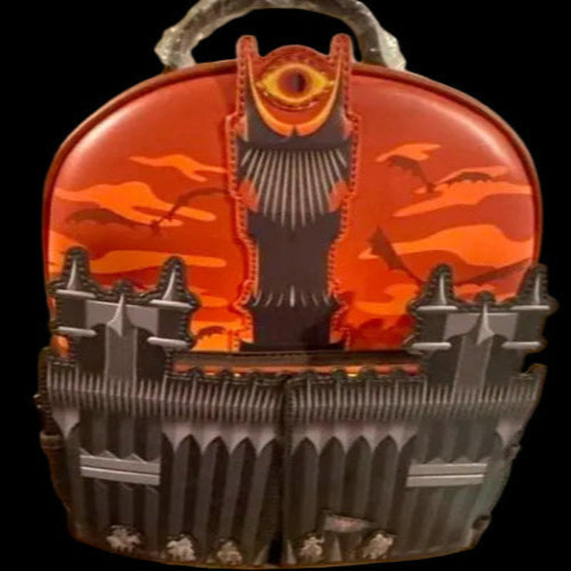 Orange and black mechanical component on a cardboard surface