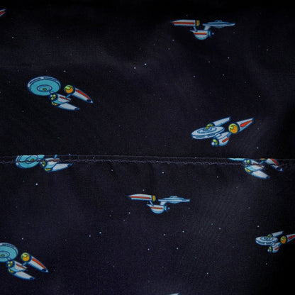Space-themed fabric with spaceship patterns on a black background