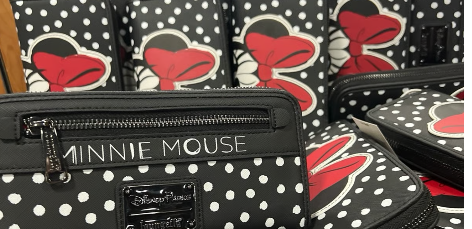 Black polka dot bag with Minnie Mouse design and branding.
