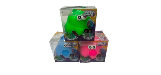 Green and pink 'Kitty Squish' toys with packaging on a white surface.