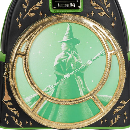 Backpack with a witch design and gold accents on a green background