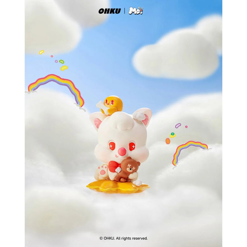 Toy figure of a cute animal character sitting on a cloud with rainbows and a blue sky background.