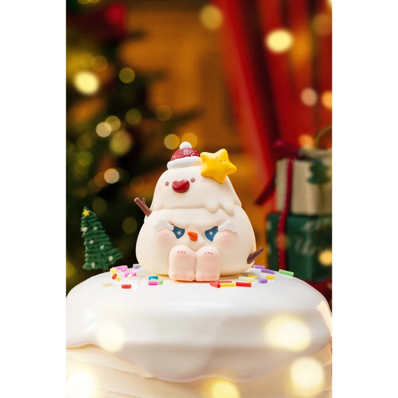Toy figure of a snowman with a star on its head, sitting on a cloud-like surface with a festive background.