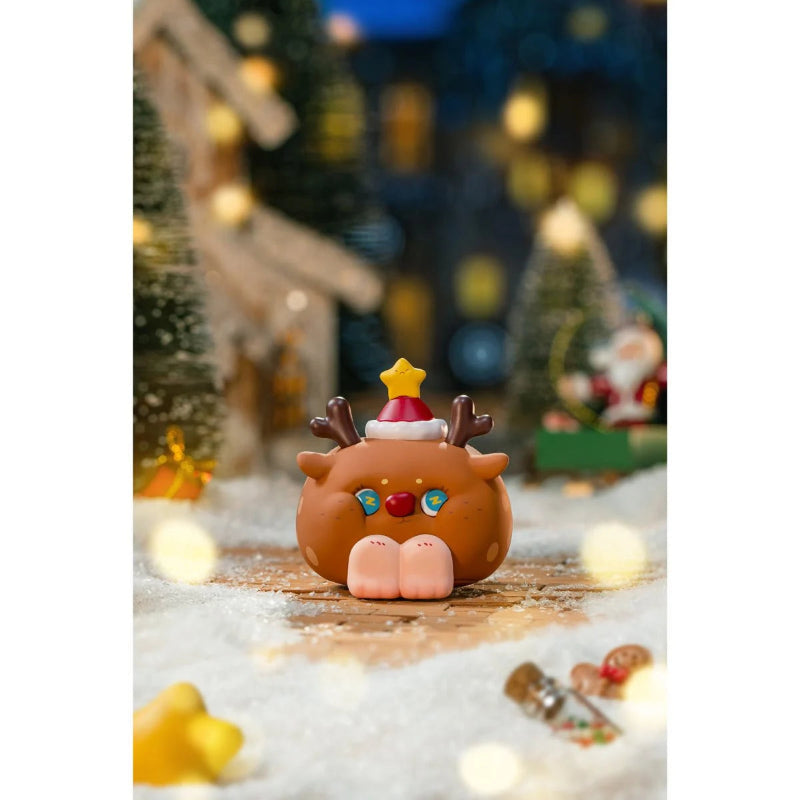Christmas-themed figurine of a reindeer with a Santa hat on a snowy background with lights and decorations.