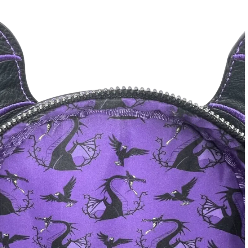 Close-up of a purple fabric accessory with black dragon silhouettes and a black zipper trim, shown against a white background.