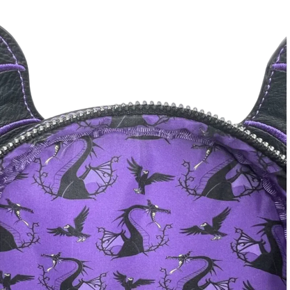 Close-up of a purple fabric accessory with black dragon silhouettes and a black zipper trim, shown against a white background.